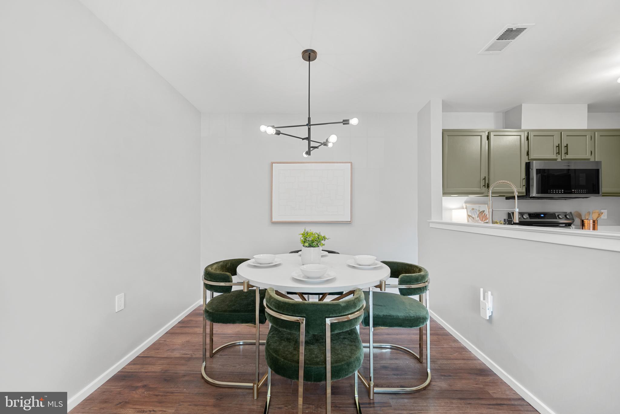 7826 Harrowgate Circle, Unit D Springfield, VA 22152 - Photo 5 of 21 a dining room with furniture and wooden floor