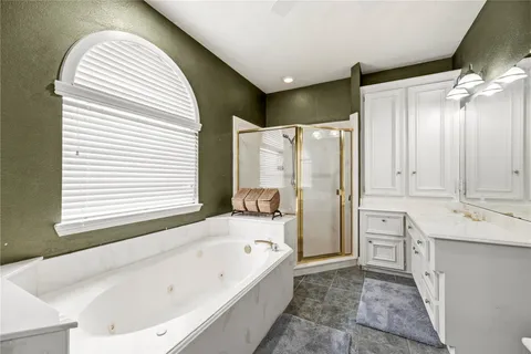 a bathroom with a tub sink and mirror