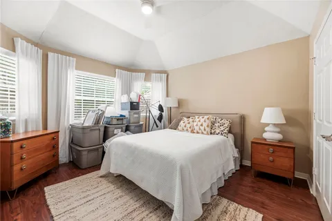 a bedroom with a bed and wooden floor