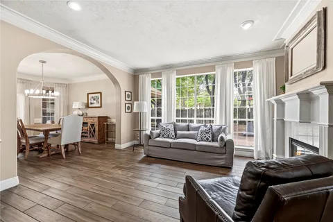 a living room with fireplace furniture and a wooden floor