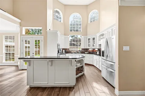 a kitchen with stainless steel appliances granite countertop a stove and white cabinets