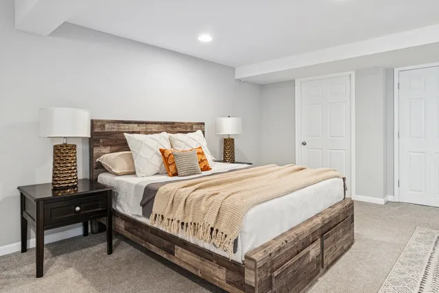 a bedroom with a bed and a night stand