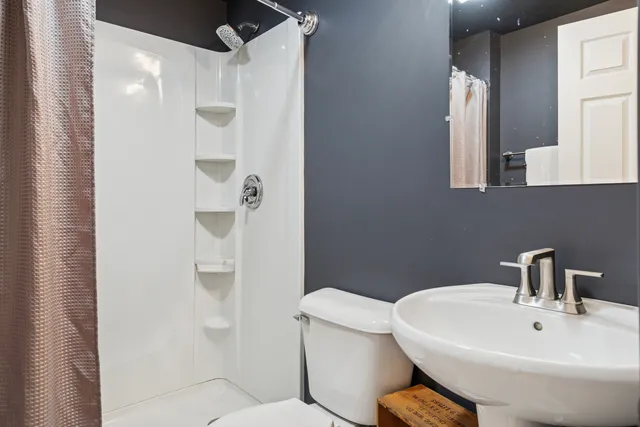 a white toilet sitting next to a bathroom sink