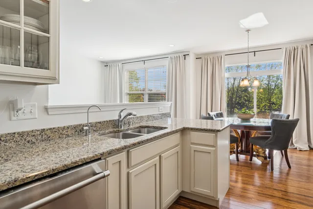 a kitchen with a sink a table and chairs