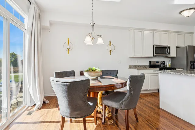 a view of a dining room with furniture wooden floor and a chandelier