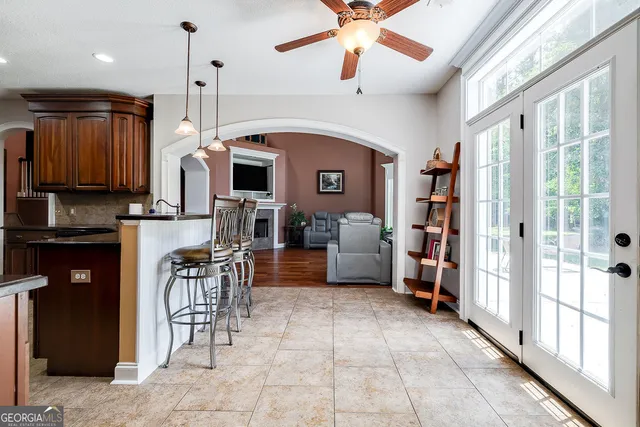a view of a kitchen with furniture and a ceiling fan