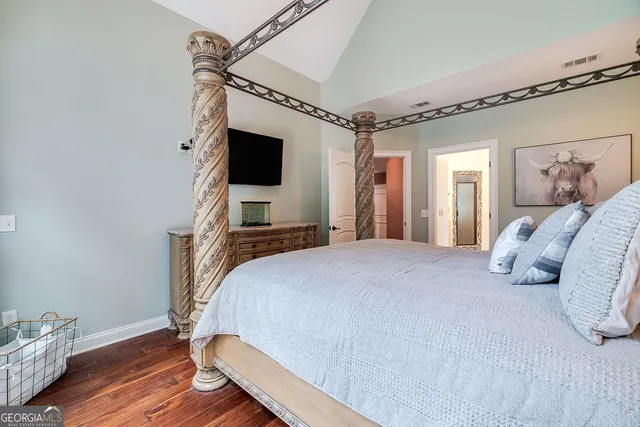 a bedroom with a bed and a flat screen tv