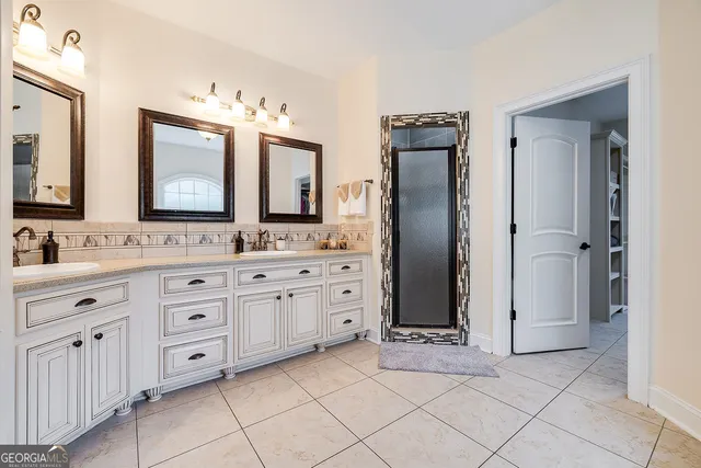 a bathroom with a double vanity sink mirror and