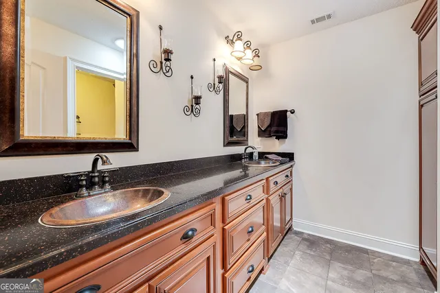a bathroom with a sink double vanity and a mirror