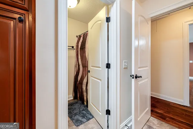 a view of walk in closet and bathroom