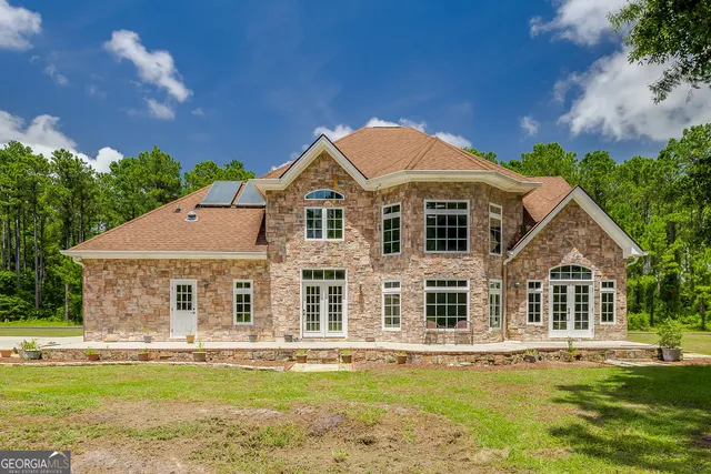 a front view of a house with a garden