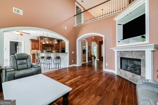 a living room with furniture a flat screen tv and a fireplace