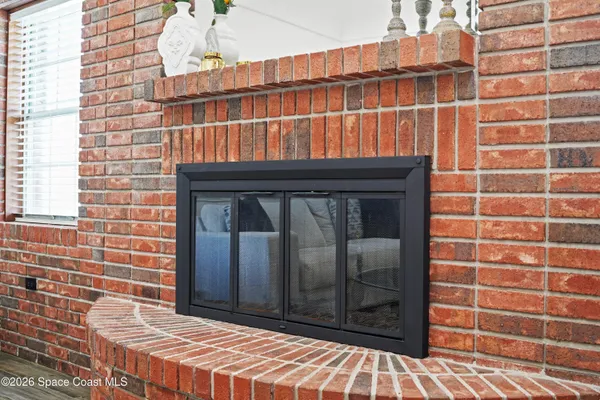 a view of a dining room with furniture a chandelier and wooden floor