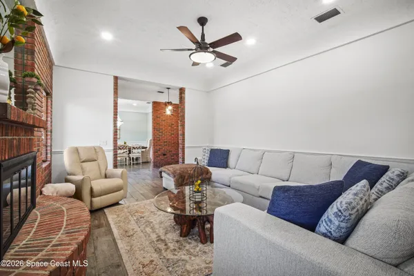 a view of a dining room with furniture and wooden floor