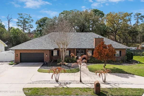 a front view of a house with a yard garage and outdoor seating