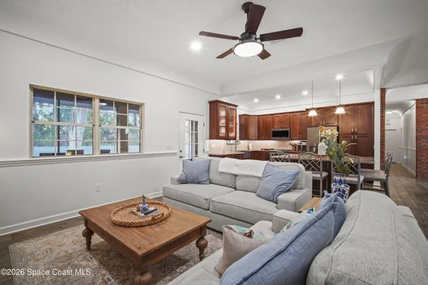 a bedroom with a bed ceiling fan and a window