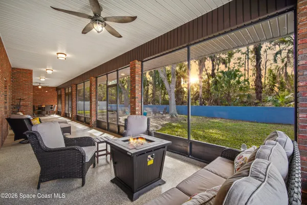 a balcony with table and chairs