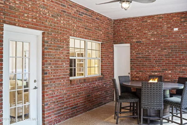 a living room with furniture and large windows