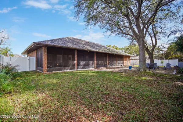 a aerial view of a residential apartment building with a yard and parking space