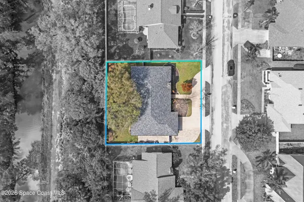an aerial view of a house with swimming pool and patio