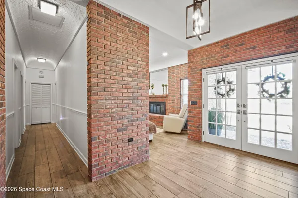 a living room with furniture a fireplace and a large window