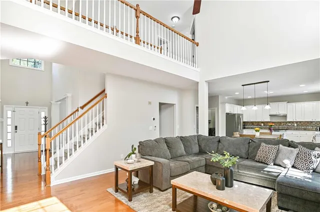 a living room with furniture and a dining table