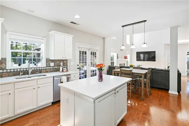 a kitchen with a sink stove and cabinets