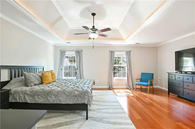 a bedroom with furniture and a flat screen tv