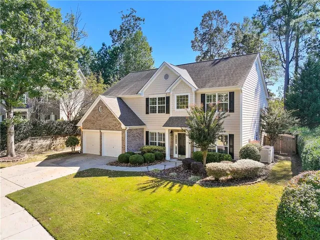 a front view of a house with swimming pool and porch
