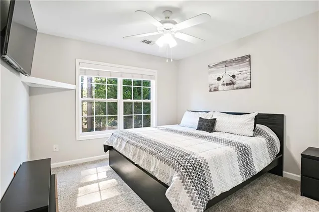 a bedroom with a large bed and a window