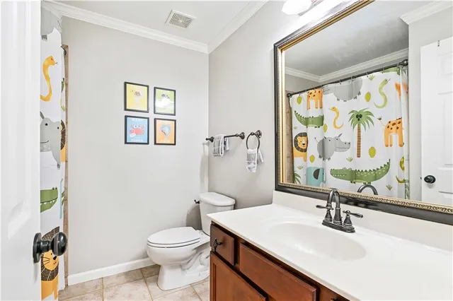 a bathroom with a sink a toilet and a window