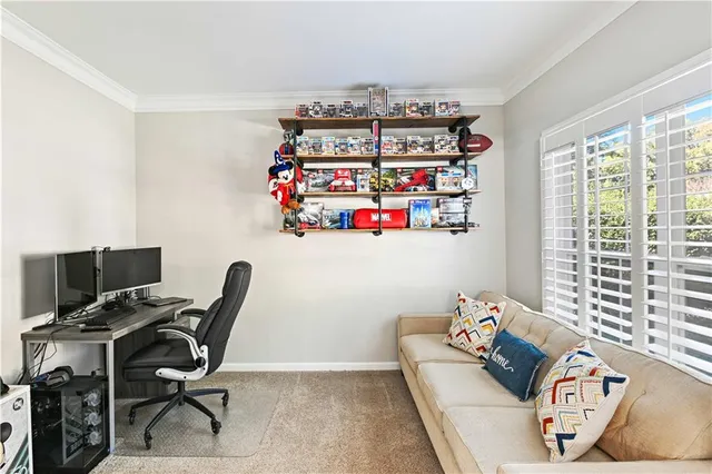 a view of a workspace with furniture and a window