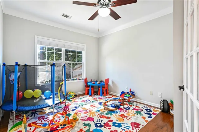 a bed room with a bed window and a chandelier