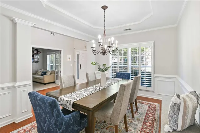 a dining room with furniture a chandelier and window