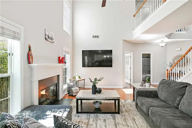 a living room with furniture a fireplace and a flat screen tv