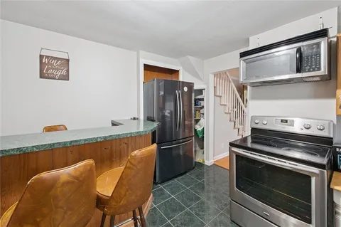 a kitchen with stainless steel appliances a stove a microwave and a refrigerator
