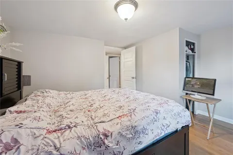 a bedroom with a bed and chair