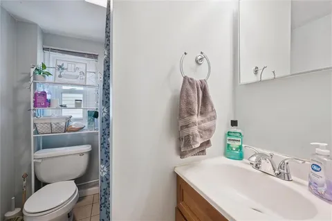 a bathroom with a sink vanity mirror and toilet