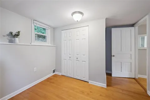 an empty room with windows and closet