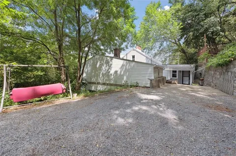 a view of a house with a yard and tree