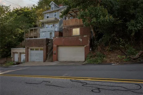 a front view of house with a garden