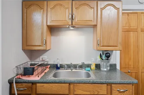 a kitchen with sink a refrigerator and cabinets