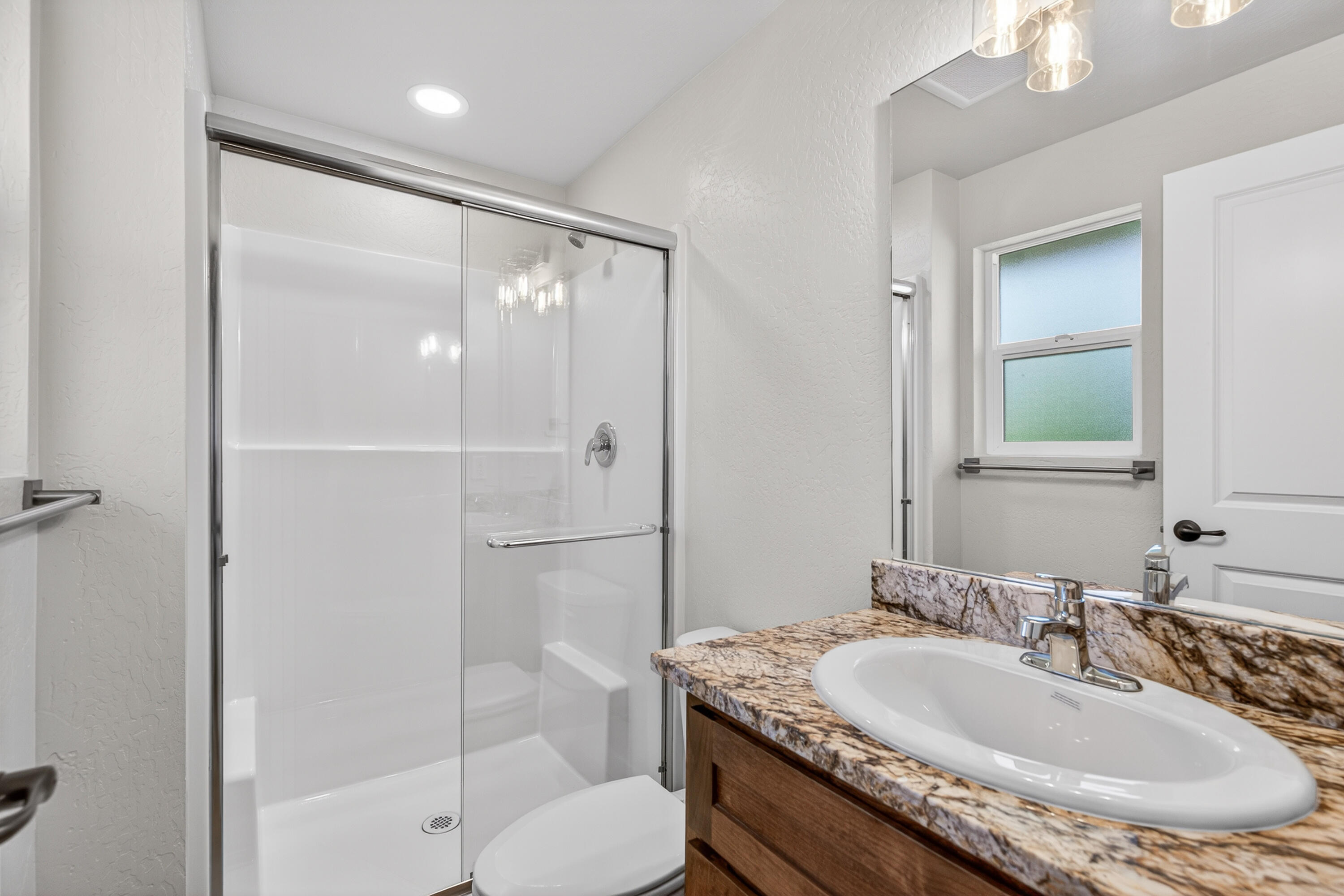 550 Experiment Station Road Medford, OR 97501 - Photo 16 of 27 a bathroom with a granite countertop sink a toilet and shower