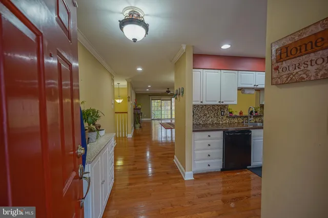 a bathroom with a granite countertop sink a mirror and shower