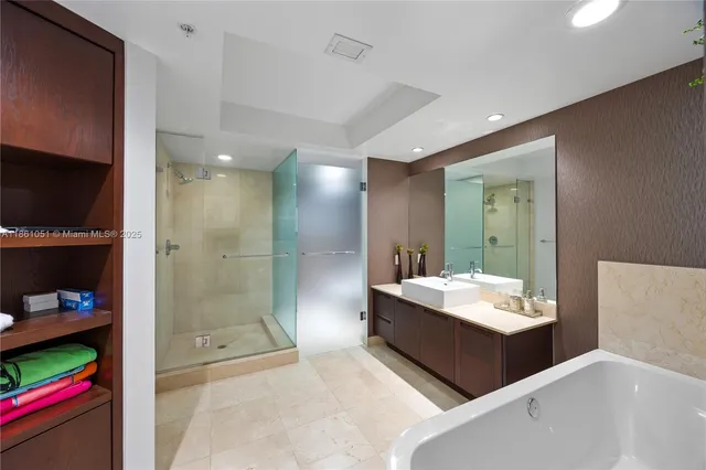 a bathroom with a tub a window and a shower