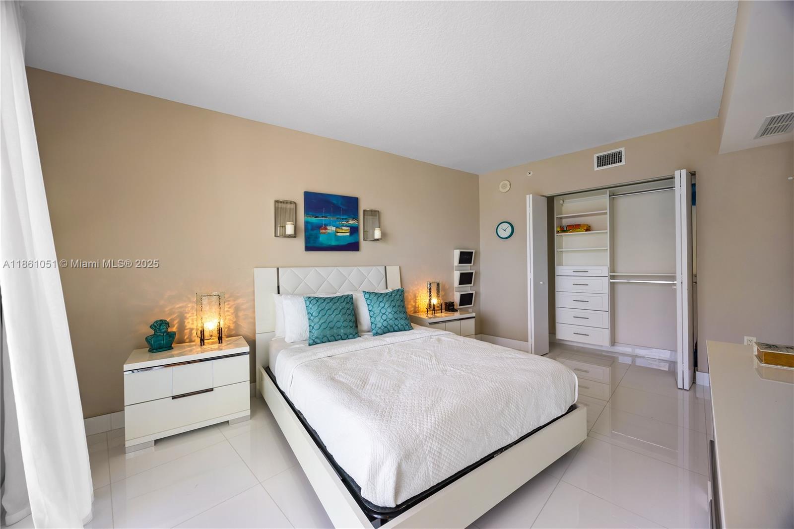 250 Sunny Isles Boulevard, Unit 31202 Sunny Isles Beach, FL 33160 - Photo 12 of 28 a bedroom with a bed and a night stand
