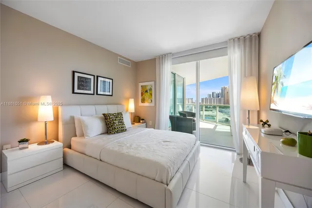 a spacious bedroom with a bed and a large window