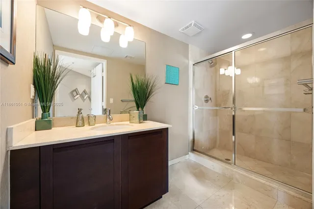 a bathroom with a shower sink and mirror