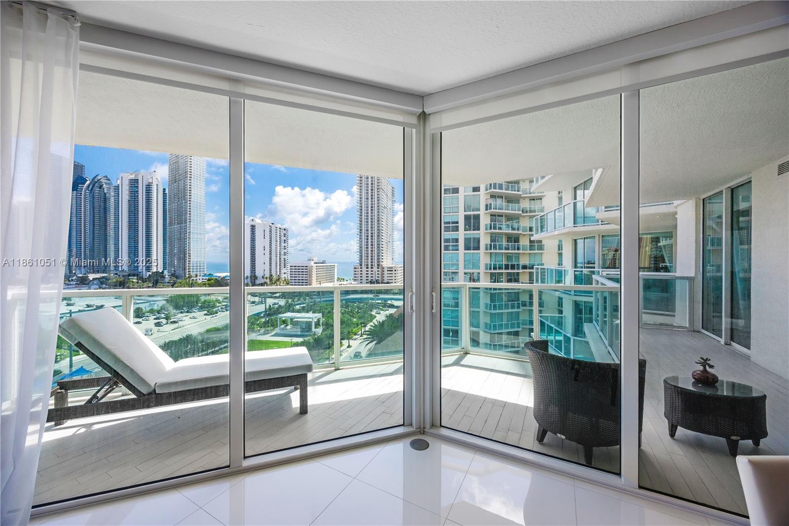 250 Sunny Isles Boulevard, Unit 31202 Sunny Isles Beach, FL 33160 - Photo 18 of 28 a view of a living room and a large window