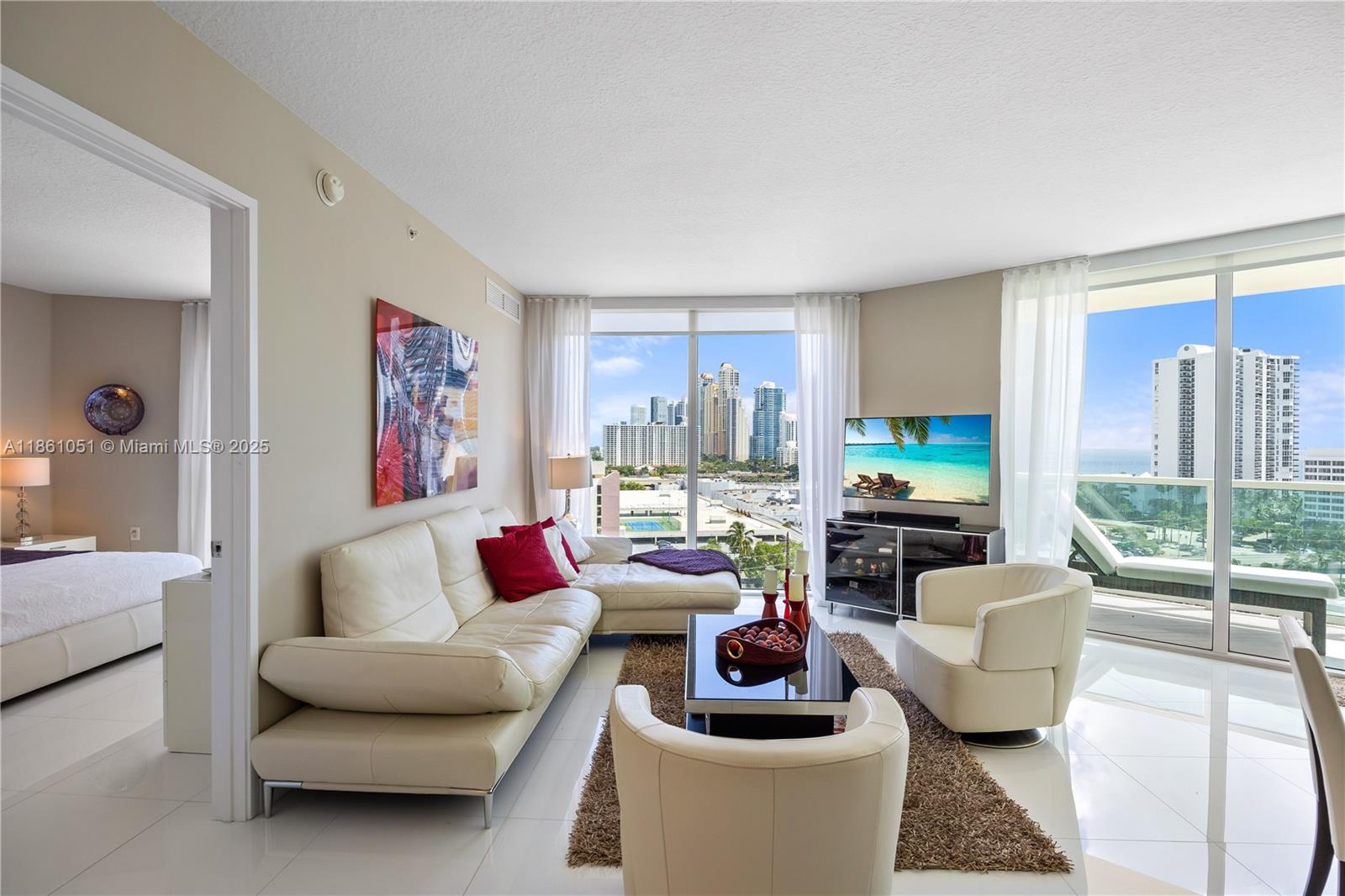 250 Sunny Isles Boulevard, Unit 31202 Sunny Isles Beach, FL 33160 - Photo 3 of 28 a living room with furniture and a large window